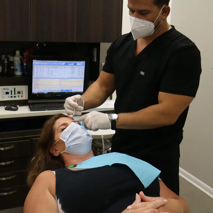 Dr. Thanasi Loukas performing a Botox injection between the eyebrows at Loukas Dentistry in Park Ridge, IL